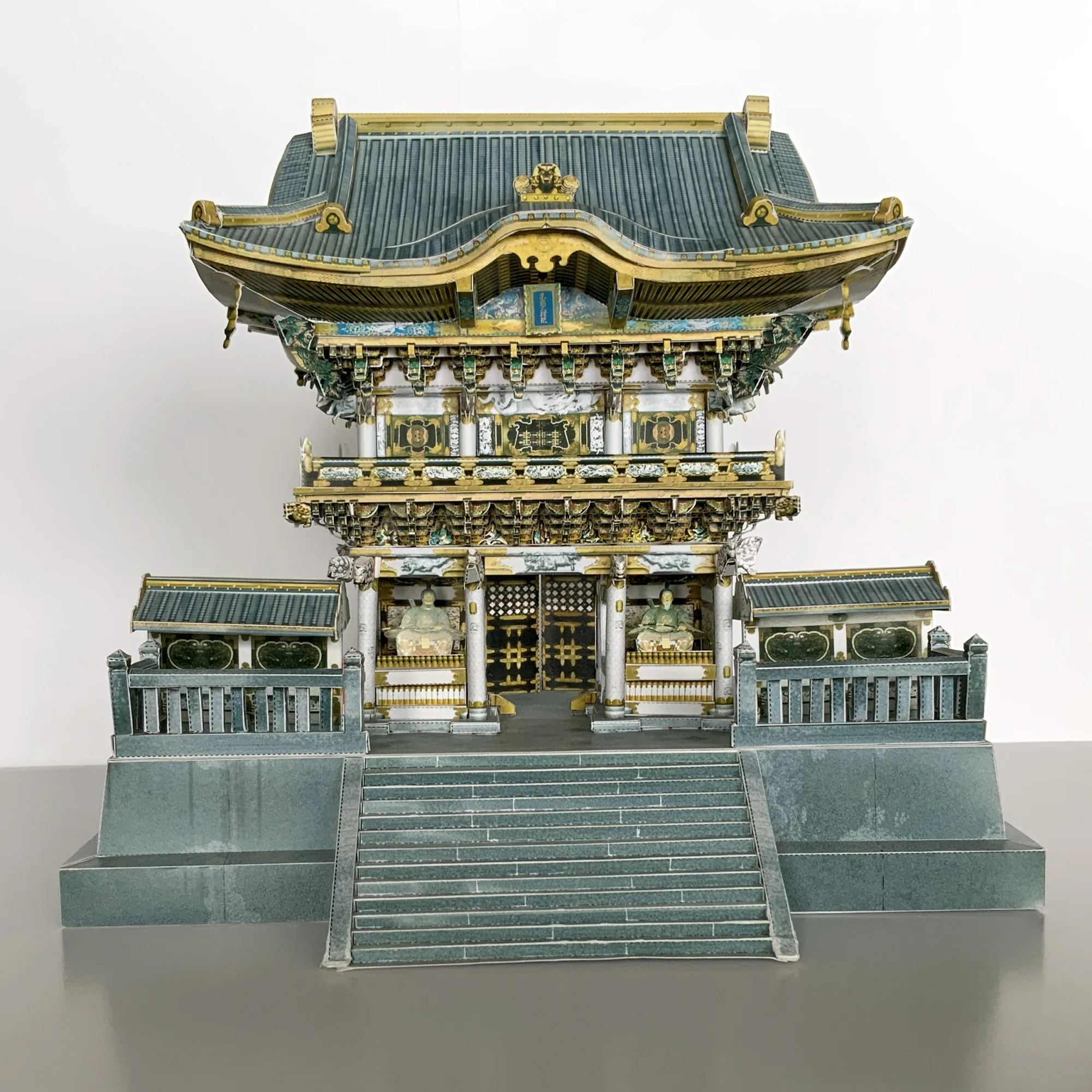 日光東照宮 陽明門の建築模型を正面から撮影。極彩色の彫刻と白い柱、左右の回廊を作り込んだペーパークラフト
